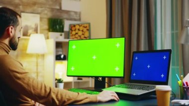Zoom in shot of engineer at this desk working on computer
