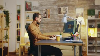 Side view of game developer working from home office