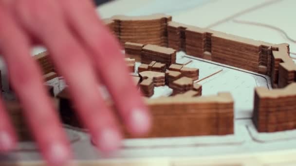 Close up of architect hand moving over city model — Stok video