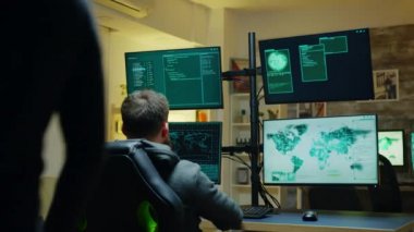 Hacker showing thumb up sign while programming a virus