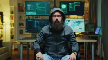 Bearded hacker wearing a hoodie using augmented technology