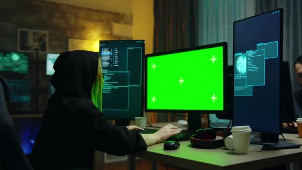 Hacker girl wearing a black hoodie in front of computer — Αρχείο Βίντεο