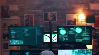 Back view of male hacker wearing a hoodie