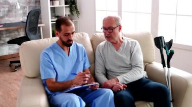 Old man in nursing home having a conversation