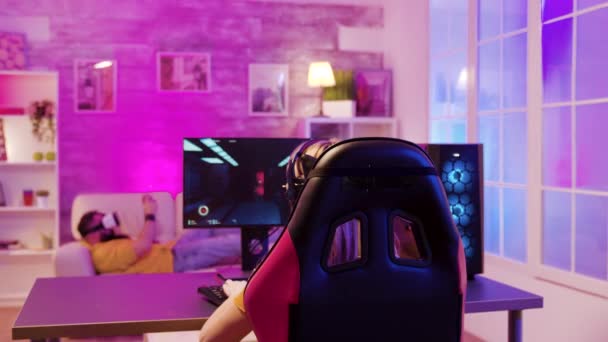 Vue arrière de gamer fille professionnelle assise sur une chaise de jeu — Video