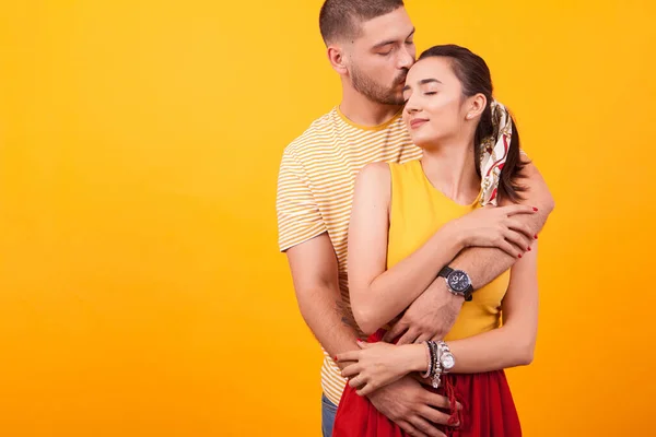 Handsome man hugging his girlfriend and kissing his girlfriend — Stock Photo, Image