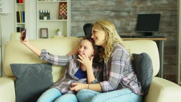 Cheerful mother and daughter taking a selfie — Stock Video