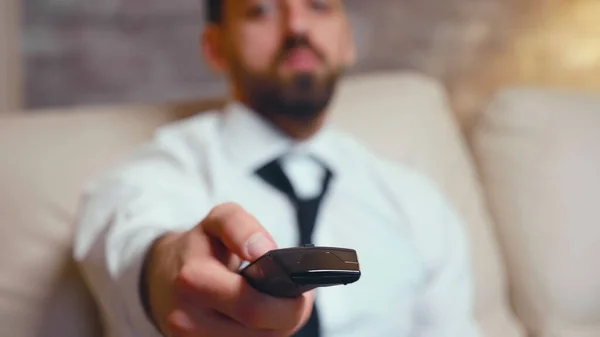 Close up of businessman using tv remote control — Stock Fotó