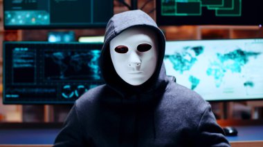 Zoom in shot cyber criminal wearing a white mask