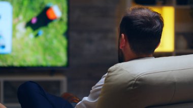 Back view of businessman taking a sip of beer