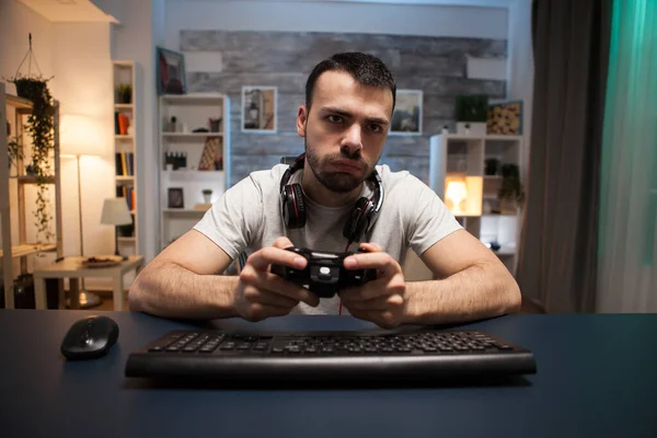 Pov van geconcentreerde jonge man spelen online shooter spel — Stockfoto