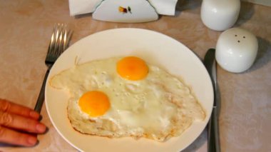 Bir masa örtüsü bir masada duran bir plaka üzerinde pişmiş yumurta hizmet.