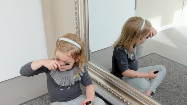 The Little Girl Makes up Eyelashes With Mother's Paint — Stock Video