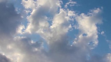 Beyaz büyük bulutlar ve onlar tarafından aydınlatılmış güneş ışınları ile güzel cennet