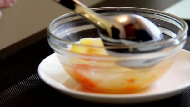 Elderly Woman Eats Chicken Soup With Meat Sitting at a Wooden Table. — Stock Video