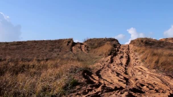 Off Road Sand Dune Motocross and Auto Sport Track on Blue Sky and White Clouds Background . Camera Moves Down — Stock Video