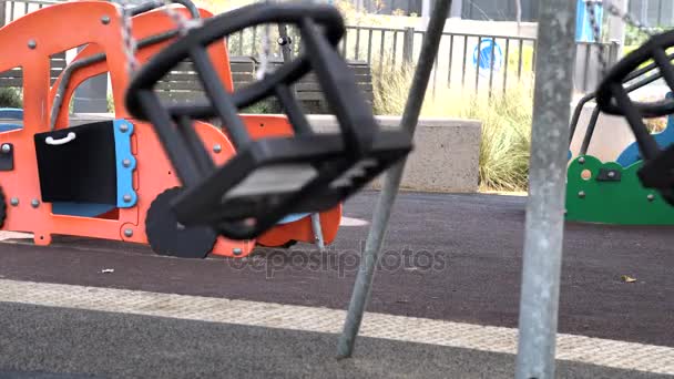 Two Empty Playground Swing on Sunny Day — Stock Video