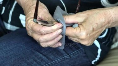 Yaşlı kadın elleri onun gözlük Temizleme