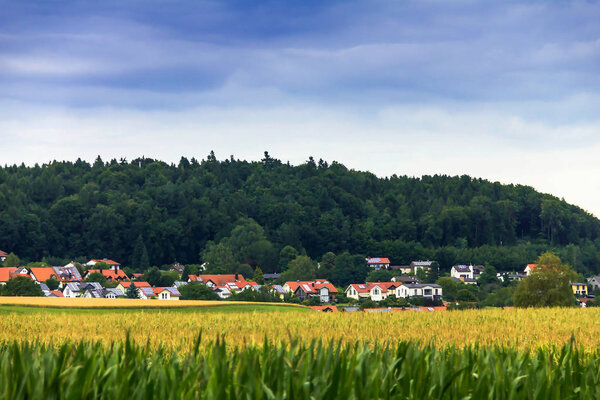 German Spring Countryside Landscape. Green rural country. Cloudy Sky. Lovely trees. Fresh vibrant colors
