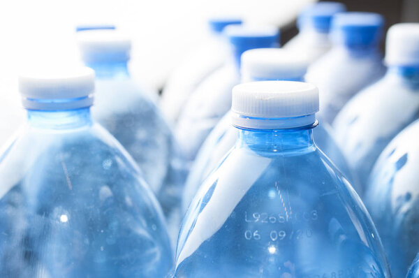 Recycling concept: empty blue water plastic bottle on white back