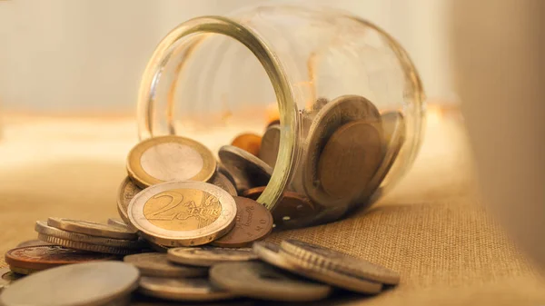 Ein Münzgefäß mit Euromünzen auf den Tisch gekippt. dieses Bild c — Stockfoto