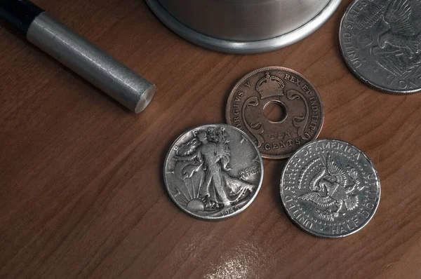 Set of old coins to perform coin magic including a walking libery and an eagle half dollar and a east Africa ten cents coin