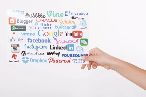 KIEV, UKRAINE - AUGUST 22, 2016: Woman hands holding collection of inscriptions, symbols of popular social media:Twitter, Google, Instagram, Pinterest, YouTube, Linkedin others printed on paper — Stock Photo, Image