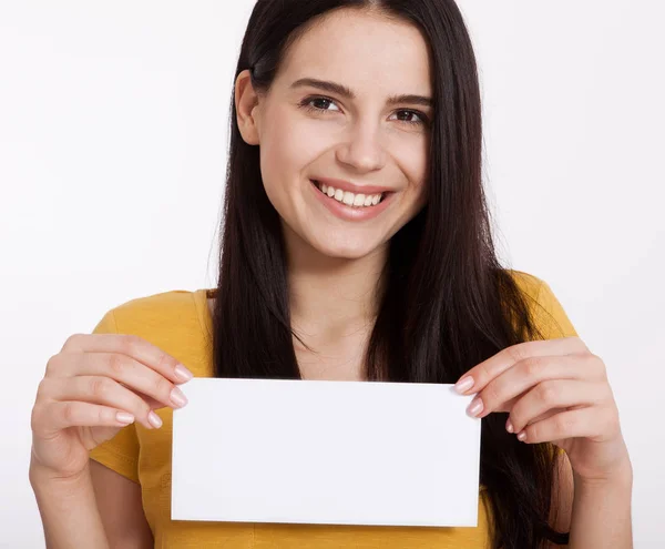 Your text here. Pretty young woman holding empty blank board. Studio portrait on white background. Mockup for design — Stock Photo, Image