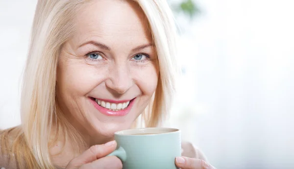 Portrait of happy blonde with mug in hands — Stok Foto