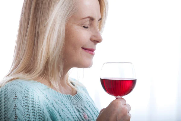 Happy blonde drinking red wine with eyes closed. — Stock Photo, Image