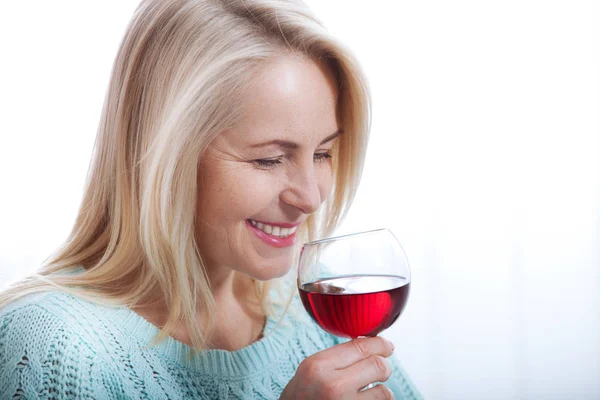 Happy blonde drinking red wine with eyes closed. — Stock Photo, Image