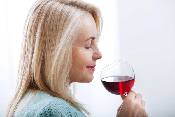 Happy blonde drinking red wine with eyes closed. — Stock Photo, Image