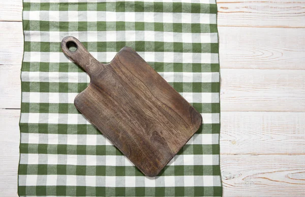 Cutting board on the wooden background. Top view. — Stock Photo, Image