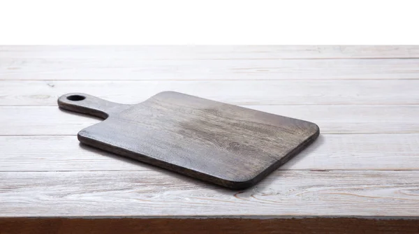 Cutting board on the wooden background. Top view. — Stock Photo, Image