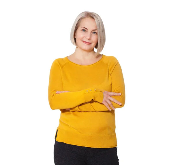 Blondine mittleren Alters posiert emotional in einem Studio. Glückliche Frau in gelbem hellen Pullover auf weißem Hintergrund — Stockfoto