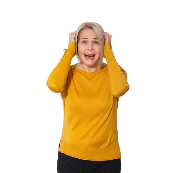 Attractive Middle Aged Woman expresses fear and horror, panic and cry, hysterics and problem, surprise and fright. Woman in bright clothes posing in studio on white background — Stock Photo, Image