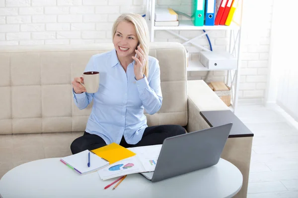 Mujer hablando por teléfono inteligente en su lugar de trabajo. Trabajo desde el concepto del hogar —  Fotos de Stock