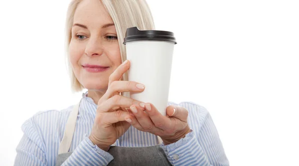 Part-time job coffee break relax leisure pause concept. Friendly pleasant woman barista giving big latte isolated on gray background copy-space — Stock Photo, Image