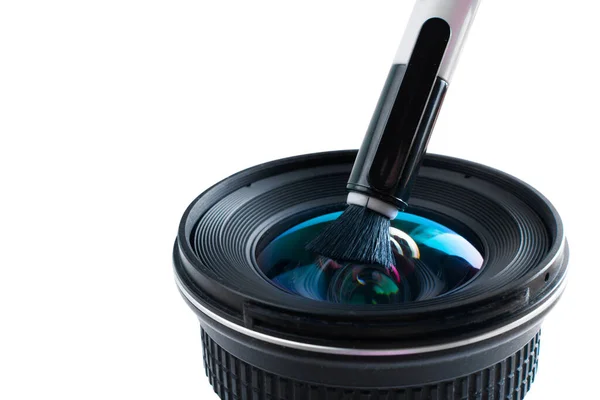 the process of cleaning the lens from dust with a special brush