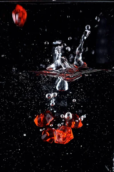 Goccia Pietre Rosse Nell Acqua Con Uno Spray Fotografia Stock