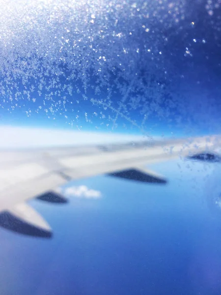 Plane wing in the frozen porthole — Stock Photo, Image