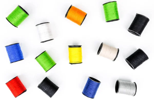 Multicolored spools of thread on white background horizontal com Stock Picture