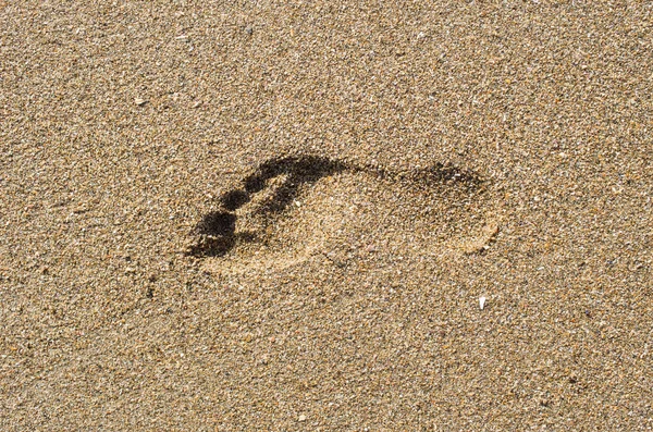 Empreintes de pas dans le sable au coucher du soleil Photo De Stock