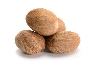 Whole nutmeg macro, four nurs of popular spice closeup isolated on white background, high resolution