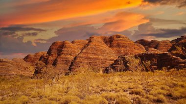 The Purnululu National Park is a World Heritage Site in the East Kimberley region of Western Australia. Photo of Bungle Bungles in the sunset clipart