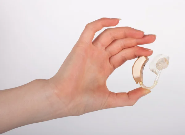 Hand showing a hearing aid with ear mouldf — Stock Photo, Image