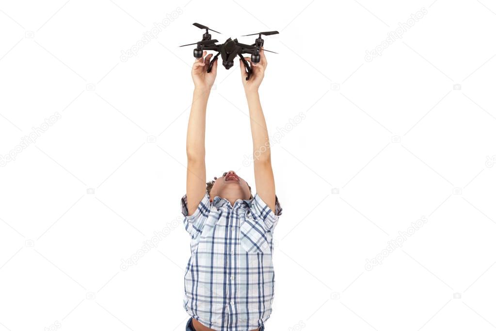 Boy holding a drone above his head. Studio shot isolated on whit