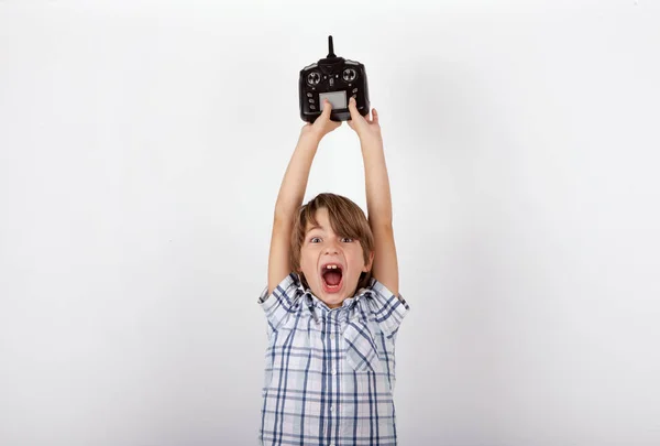 Menino alegre mostrando seu controle remoto drone — Fotografia de Stock