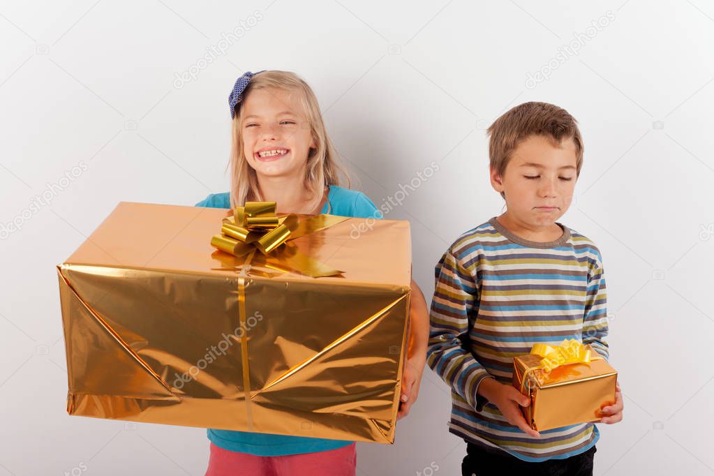 Girl happy with a big present box but her brother has only a sma