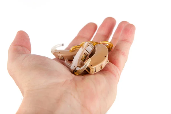 Hand showing used and old hearing aids — Stock Photo, Image